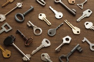 Assorted metal keys laid out on a wooden surface – Knoxmith Lock & Key Knoxville