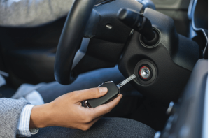 A driver inserting a new car key into the ignition, provided by Knoxmith Lock & Key, the trusted automotive locksmith in Knoxville, TN