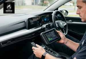 Locksmith programming a new car key.